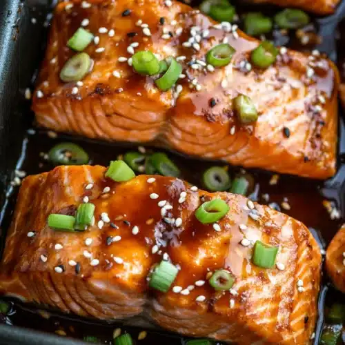 Baked Teriyaki Salmon Recipe with glossy glaze and scallions.