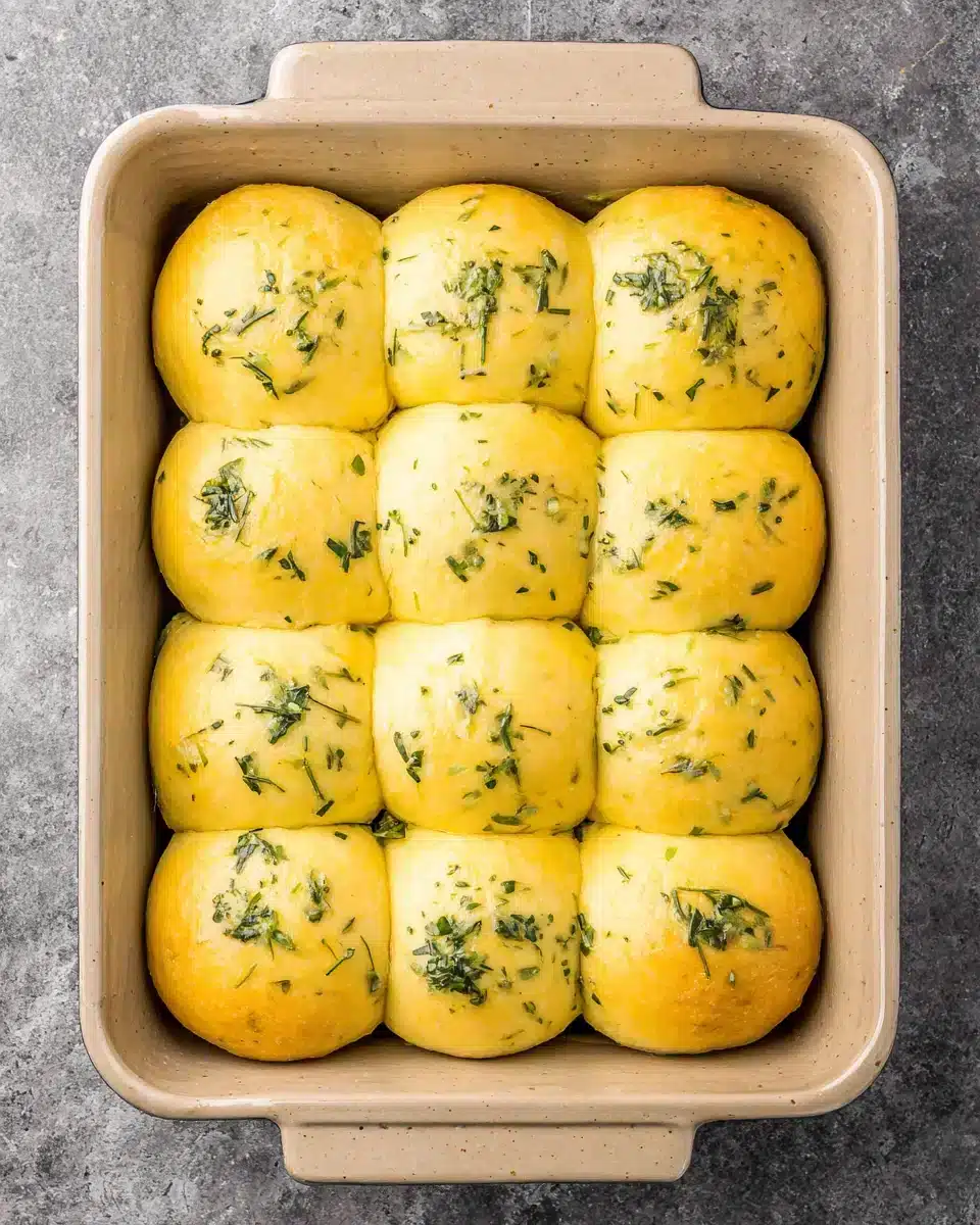 Fresh Garlic Bread Rolls A batch of Garlic Bread Rolls with a golden crust and visible herbs.
