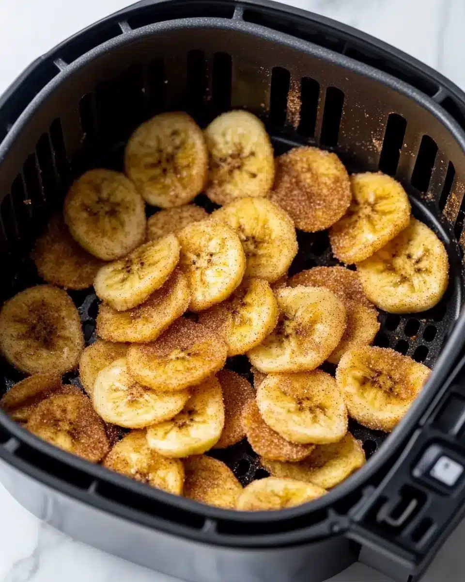 Sweet Cinnamon Air Fryer Banana Chips Sweet Cinnamon Air Fryer Banana Chips in a basket, showcasing a crispy snack.