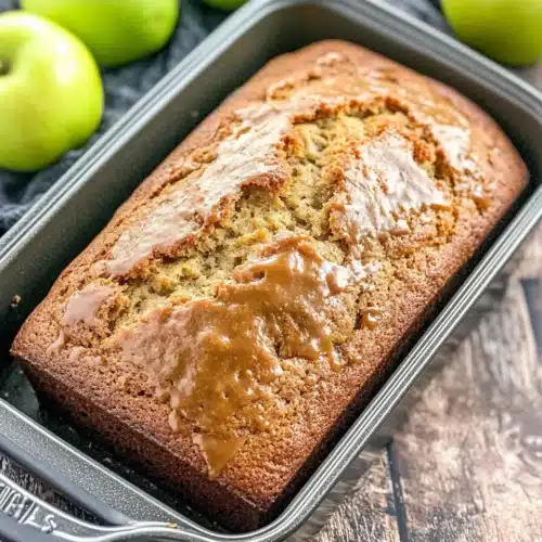 Delicious caramel apple bread displayed with fresh apples. Keyword: Caramel Apple Bread