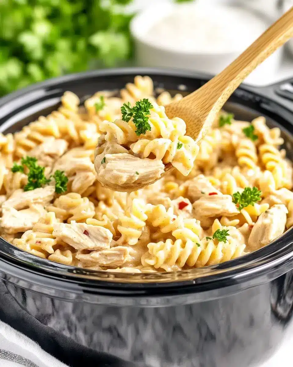 Crock Pot Garlic Parmesan Chicken Pasta Delicious Crock Pot Garlic Parmesan Chicken Pasta served with herbs.