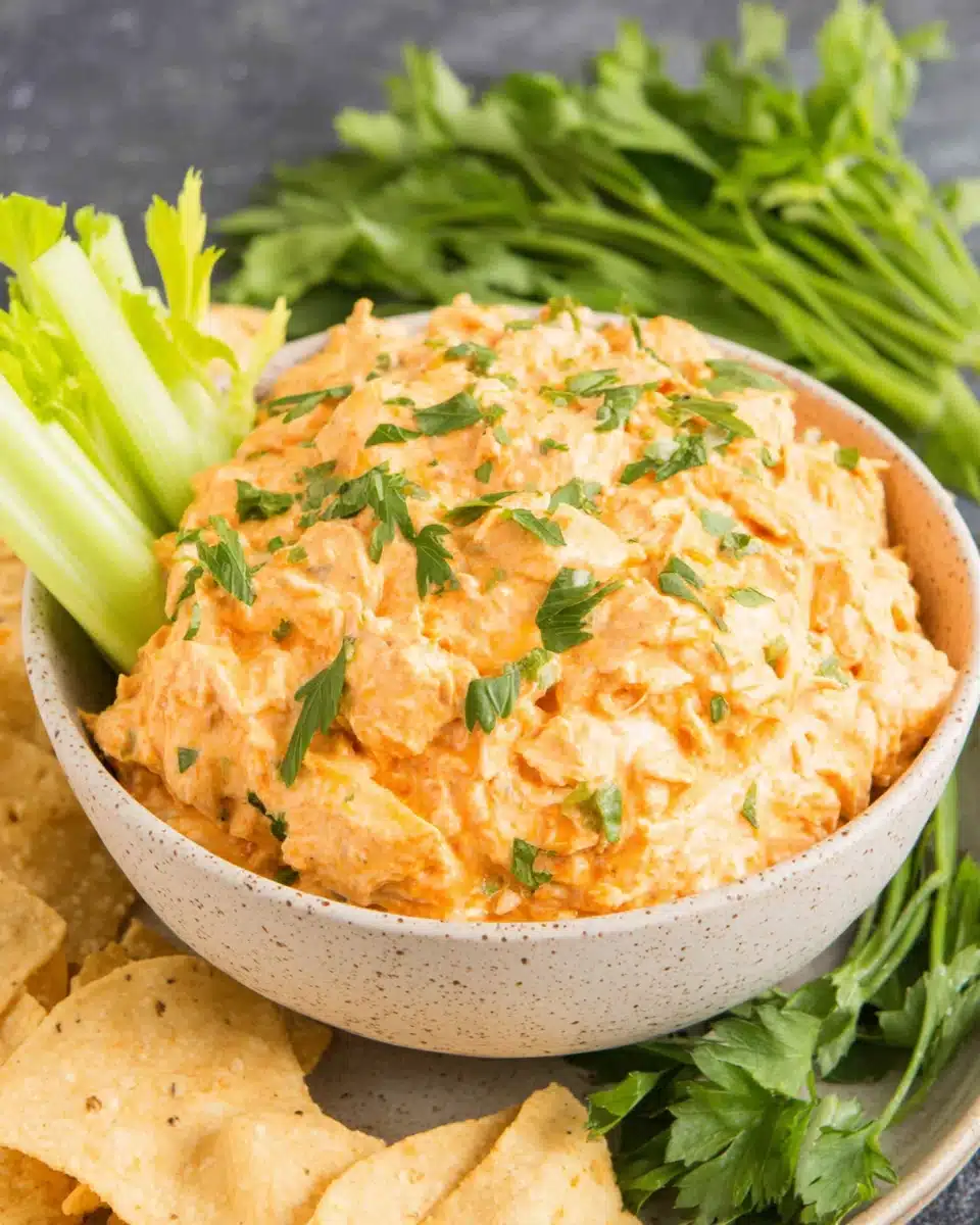 Buffalo chicken dip served with tortilla chips and celery.