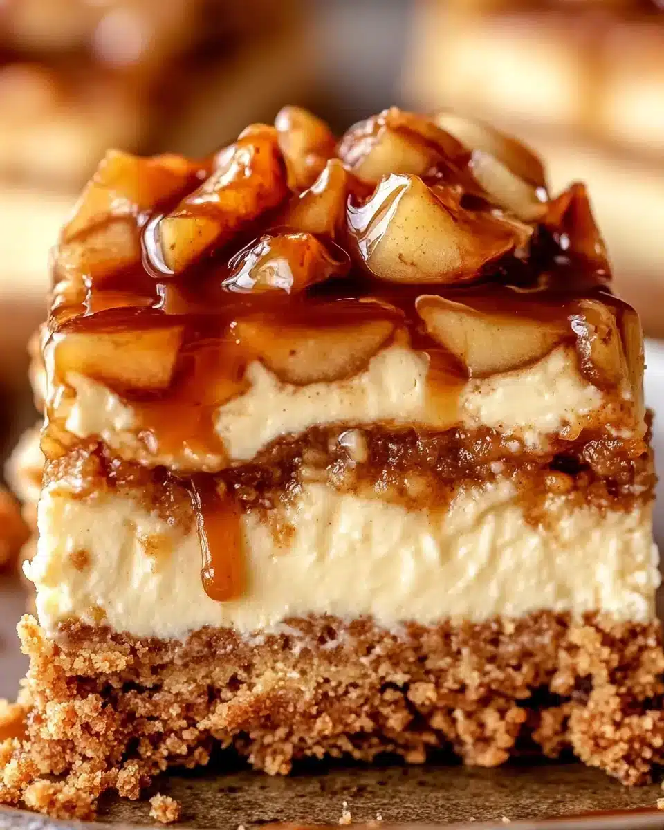 Indulgent Caramel Apple Cheesecake Bars Delicious Caramel Apple Cheesecake Bars with caramel drizzle and apples.