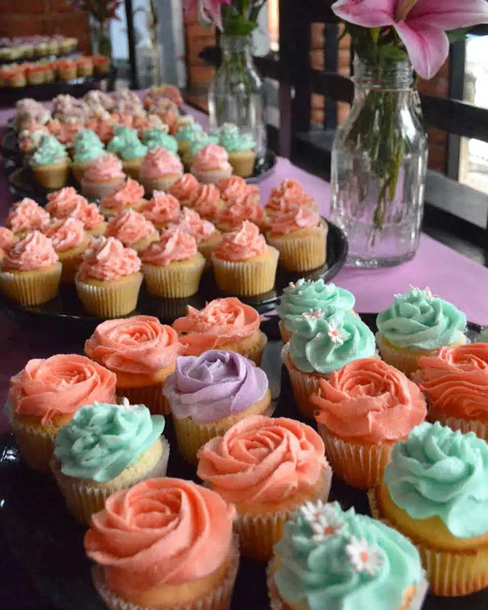 Colorful Flower Cupcakes Display Colorful flower cupcakes with vibrant frosting designs.