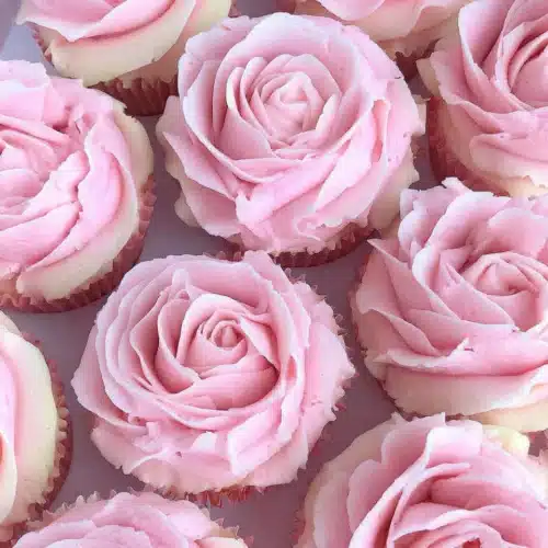 Flower cupcakes with pink rose frosting design.
