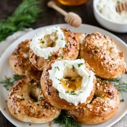 Delicious gluten free bagels with cream cheese and honey.