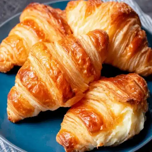 Homemade Croissants: Delightfully Flaky and Buttery 1 Delicious homemade croissants on a blue plate.