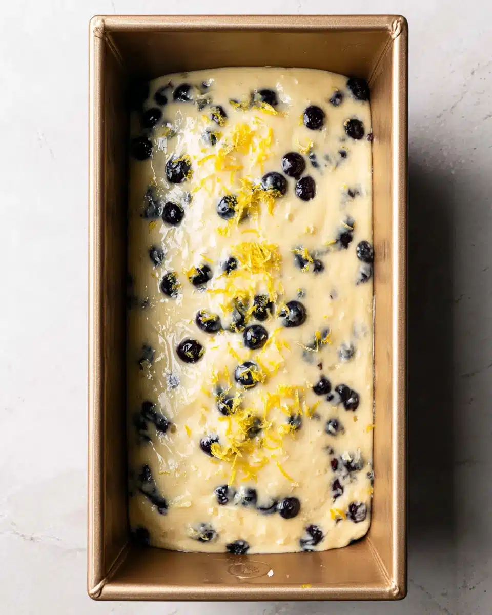 Lemon blueberry bread mixture in a pan.