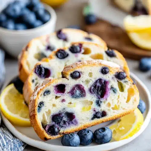 Sliced lemon blueberry sourdough bread with blueberries.