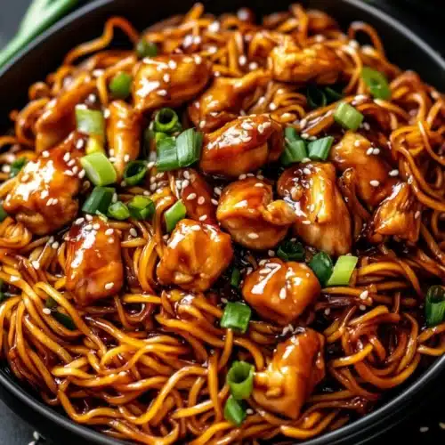 Sticky Garlic Chicken Noodles Recipe served in a bowl with details.