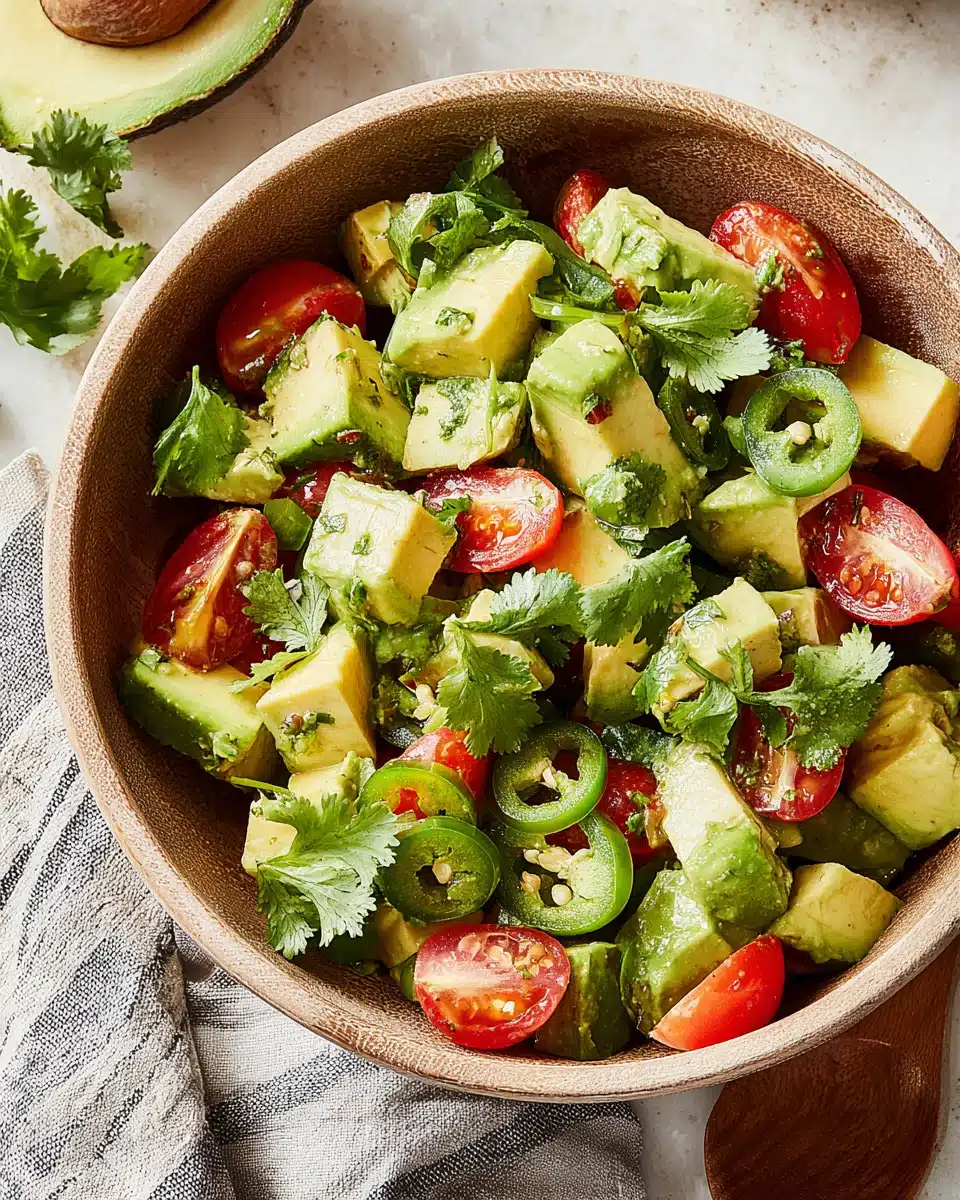 Fresh avocado salad with tomatoes and cilantro.