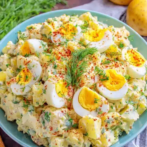 Delicious deviled egg potato salad featuring halved eggs on top.