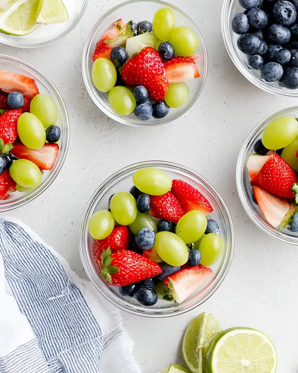 Delicious honey lime fruit salad with fresh strawberries, grapes, and blueberries.