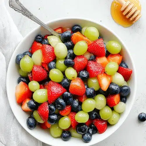 Delicious honey lime fruit salad with assorted fresh fruits.