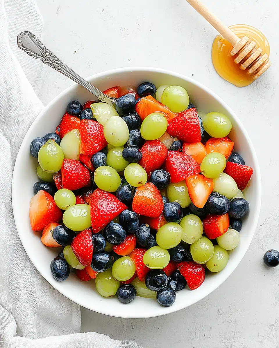 Delicious honey lime fruit salad with assorted fresh fruits.