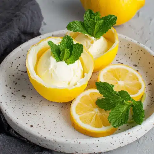 Delicious lemon posset dessert in lemon shells.