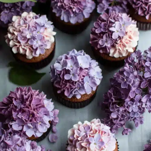 Delightful lilac cupcakes topped with floral frosting