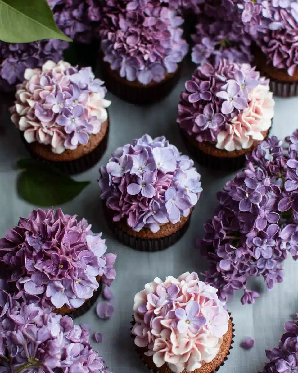 Delightful lilac cupcakes topped with floral frosting