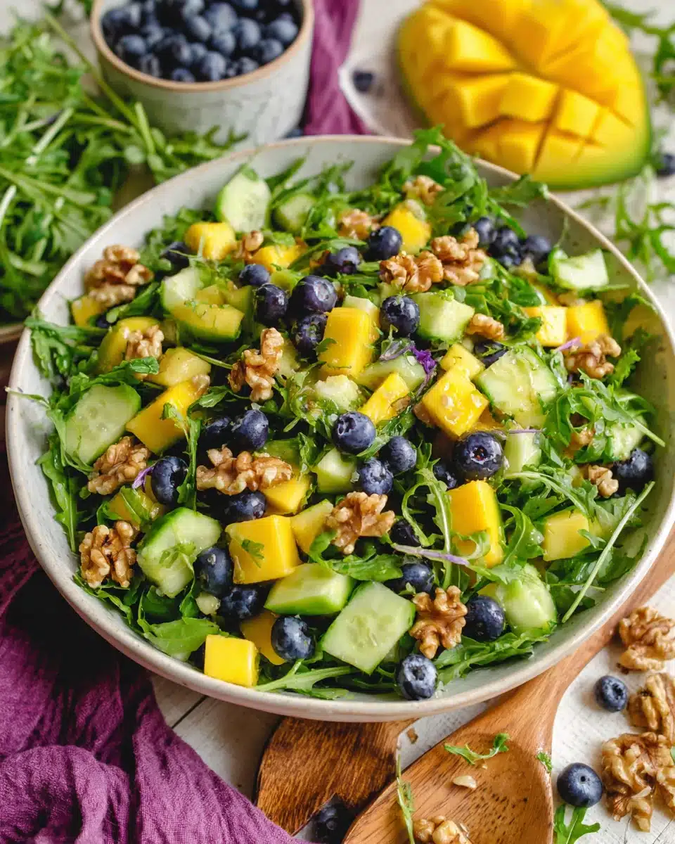 Refreshing mango cucumber salad with arugula and walnuts.