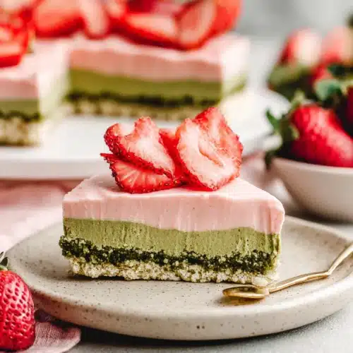 Delicious Matcha Strawberry Dessert for Everyone 1 Delicious matcha strawberry dessert with layers of pink cream and shortbread.