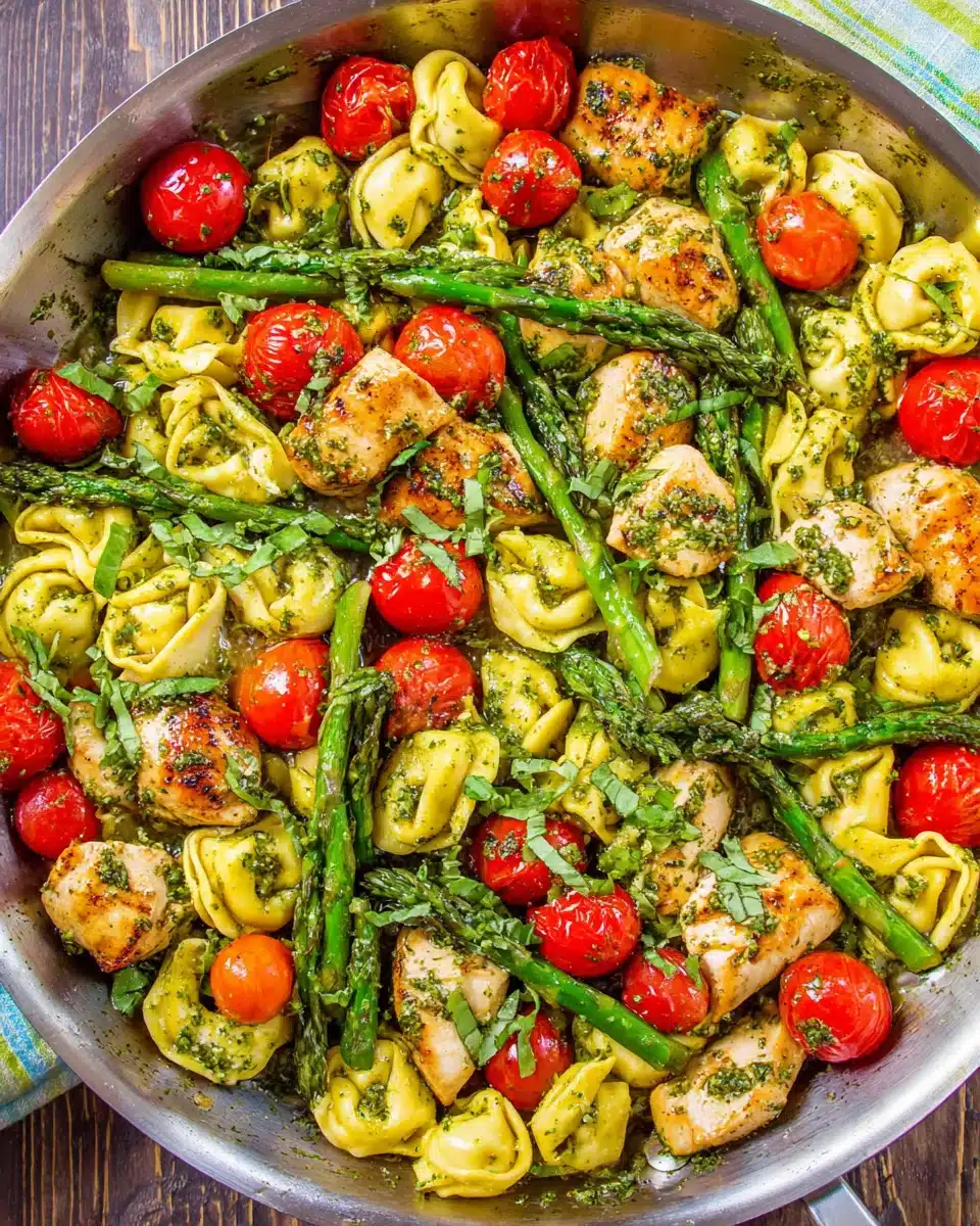 Healthy Pesto Chicken Tortellini Recipe Pesto chicken tortellini with asparagus and cherry tomatoes.