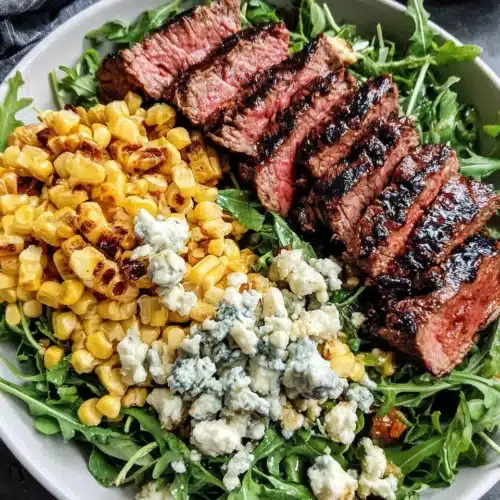Delicious steak salad with corn, Gorgonzola, and arugula.