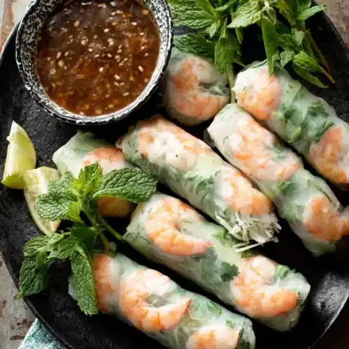 Delicious Vietnamese summer rolls served with a dipping sauce.