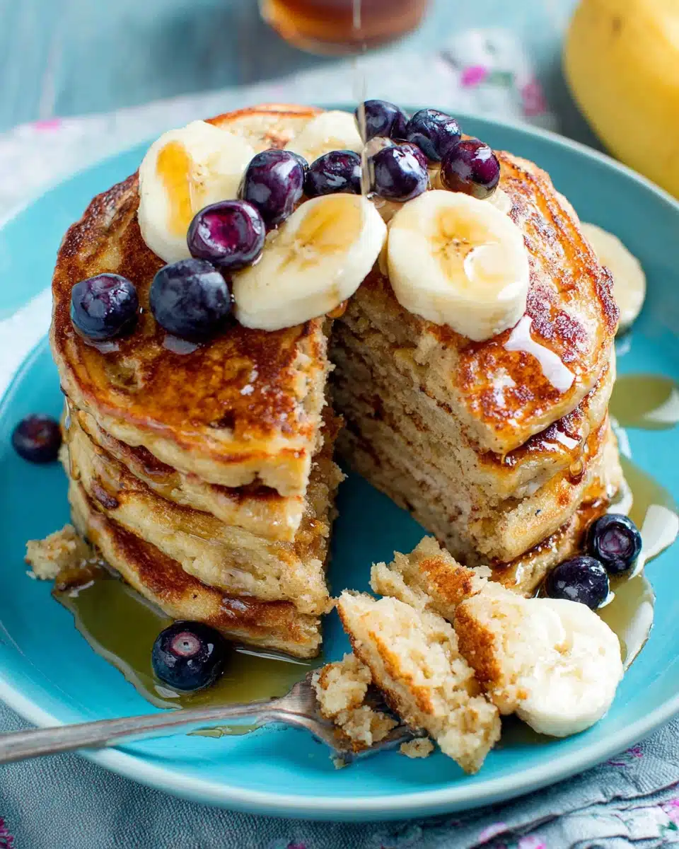 Moist bread free banana oatmeal pancakes stacked with toppings