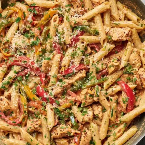 Creamy Cajun chicken pasta with colorful peppers and Parmesan.