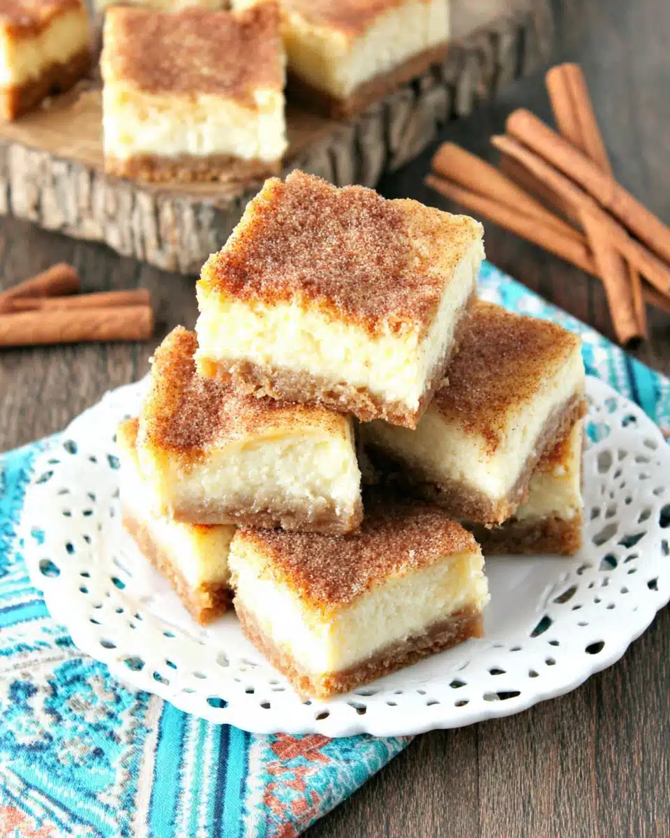Delicious churro cheesecake bars with a cinnamon sugar crust.