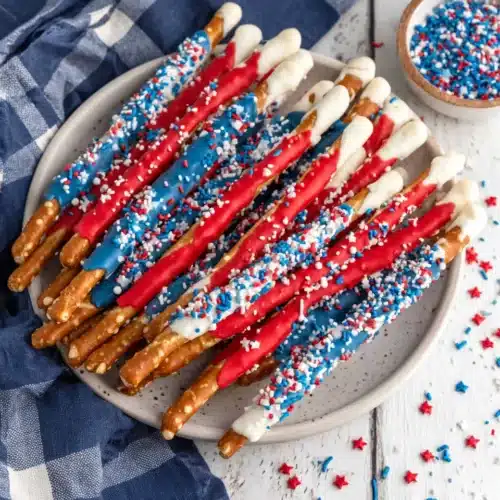 Fourth Of July Pretzel Rods with festive colors and sprinkles.
