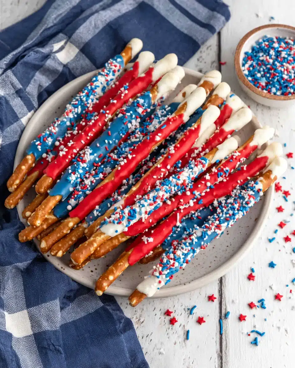 Fourth Of July Pretzel Rods with festive colors and sprinkles.