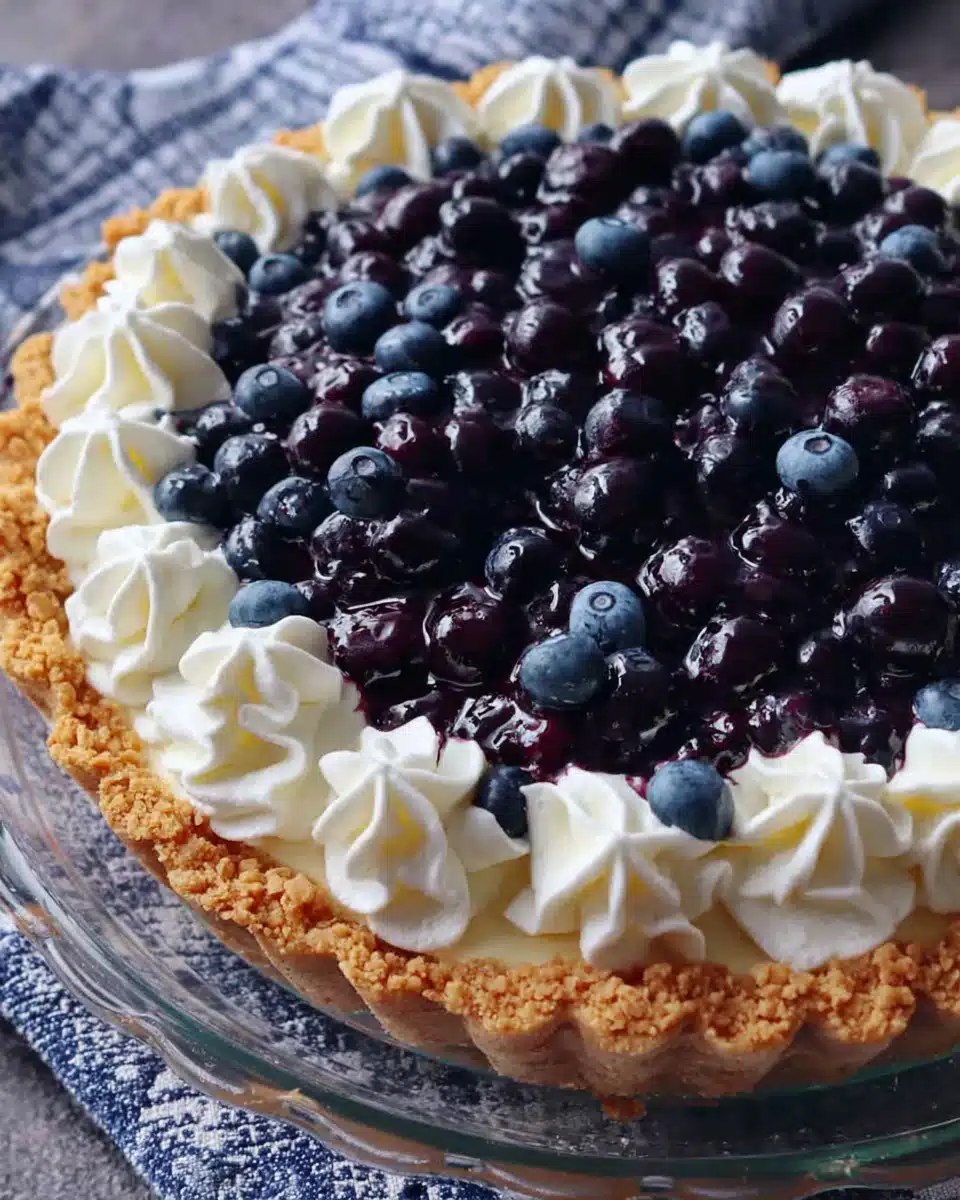 Blueberry cream cheese pie with fresh blueberries and whipped cream topping