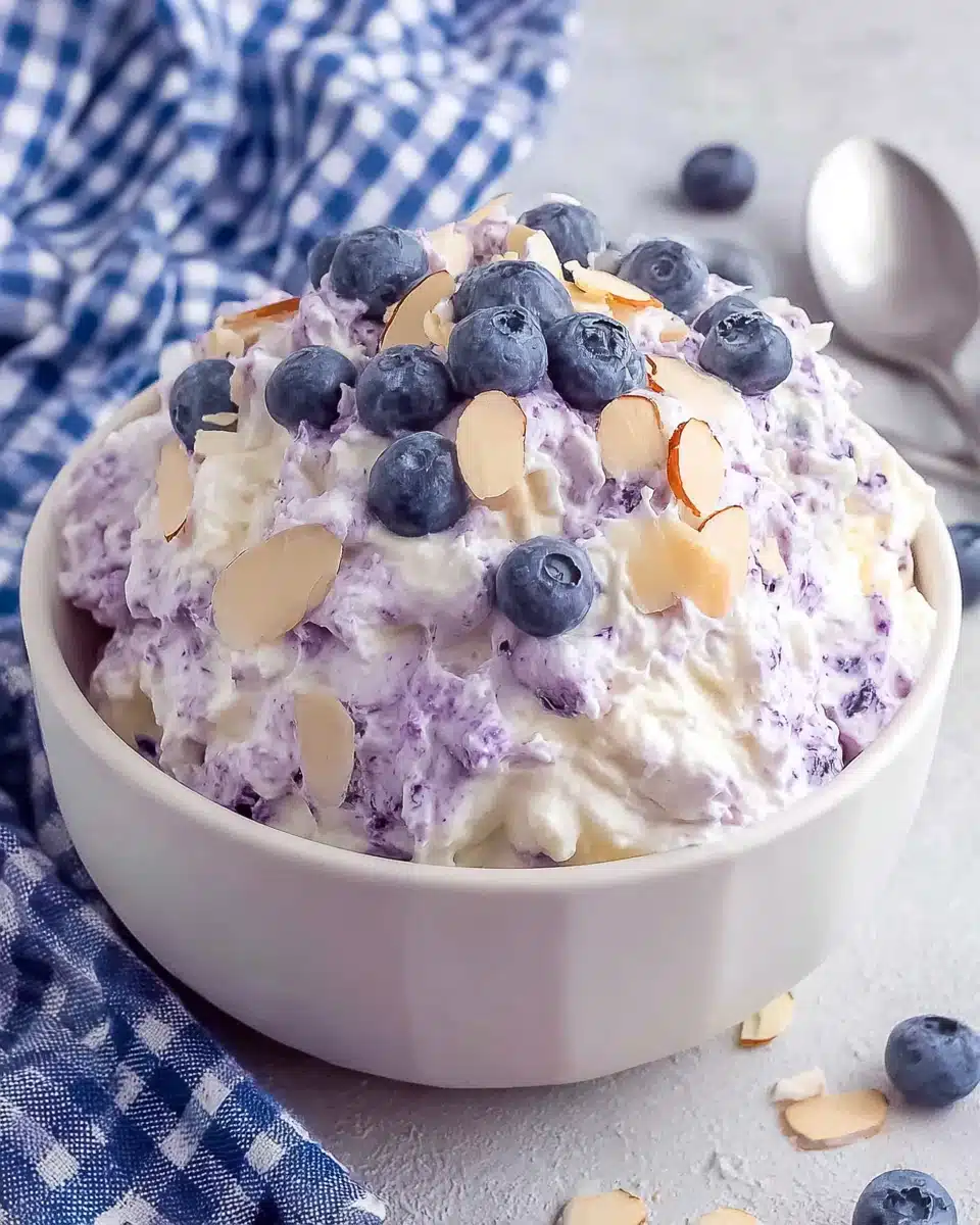 Blueberry fluff salad with fresh blueberries and almonds in a white bowl
