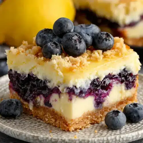 Blueberry Lemon Pie Bars: A Delightful Treat 1 Blueberry lemon pie bar with fresh blueberries and creamy filling on a plate