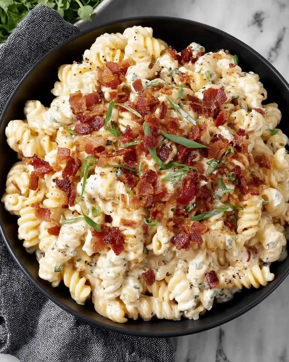 Cheddar Ranch Pasta Salad with Bacon and Green Onions Creamy cheddar ranch pasta salad with bacon and green onions in a black bowl