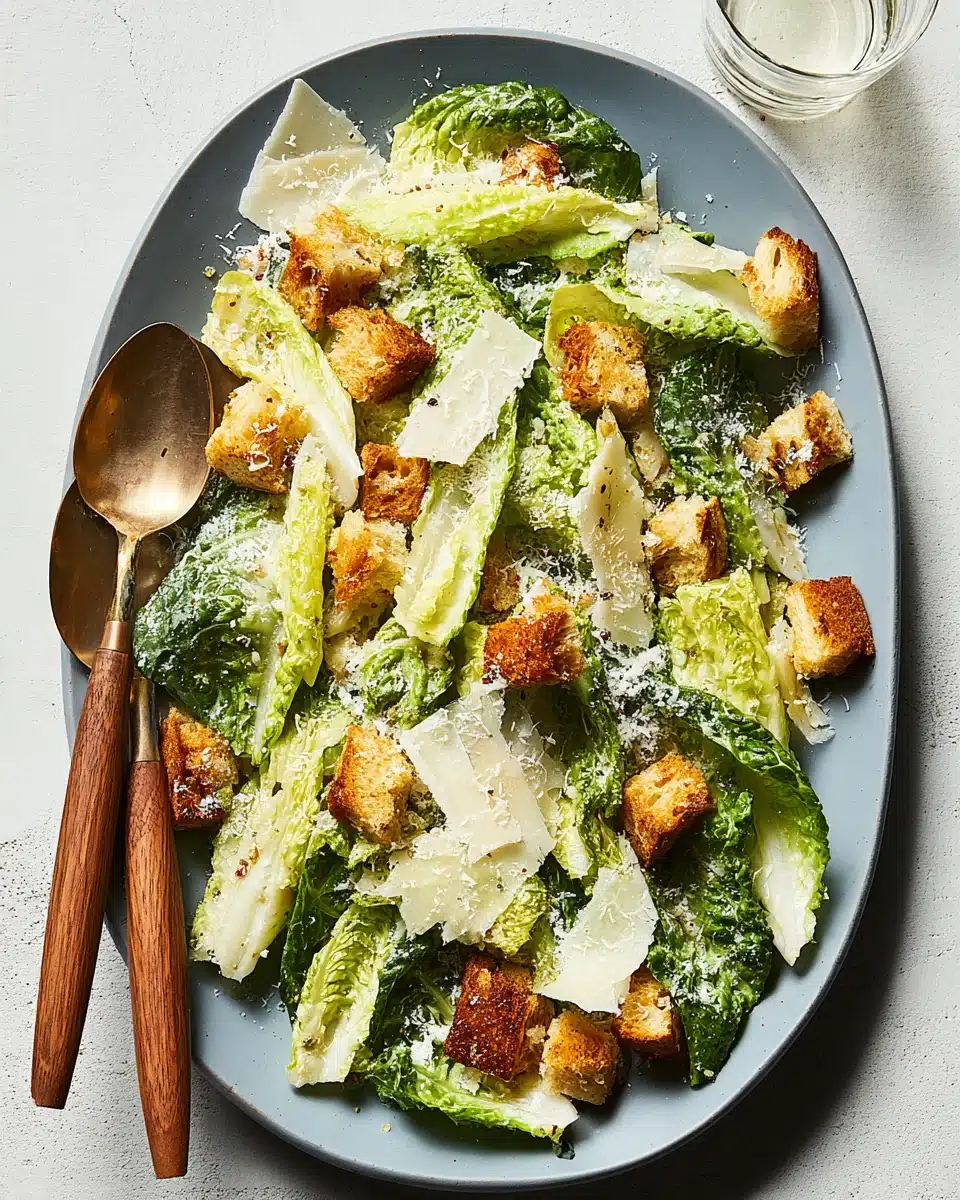 Classic Caesar salad with romaine, croutons, and Parmesan on a blue plate