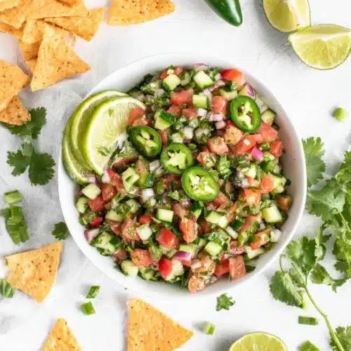 Cucumber Pico de Gallo: A Fresh and Vibrant Delight 1 Cucumber pico de gallo in a white bowl with lime and jalapeño garnish