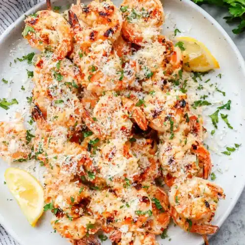 Grilled shrimp kabobs with lemon garlic, garnished with parsley and cheese