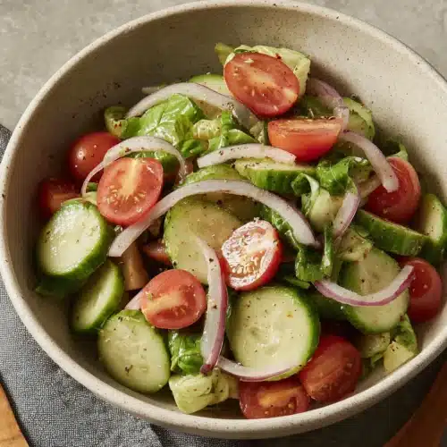 Italian cucumber salad with fresh veggies and vibrant dressing.
