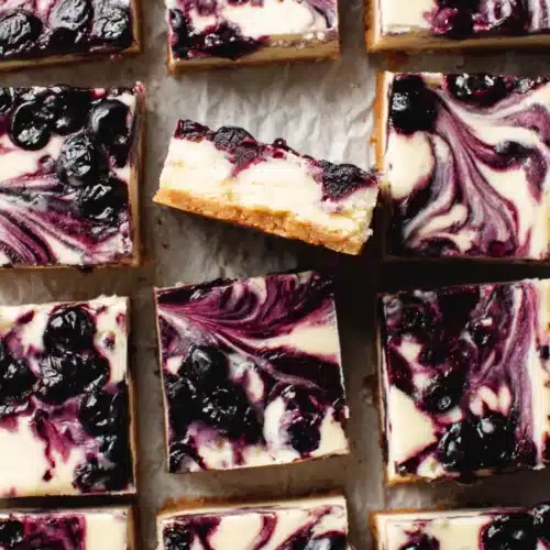 Lemon blueberry cheesecake bars with creamy filling and blueberry swirl