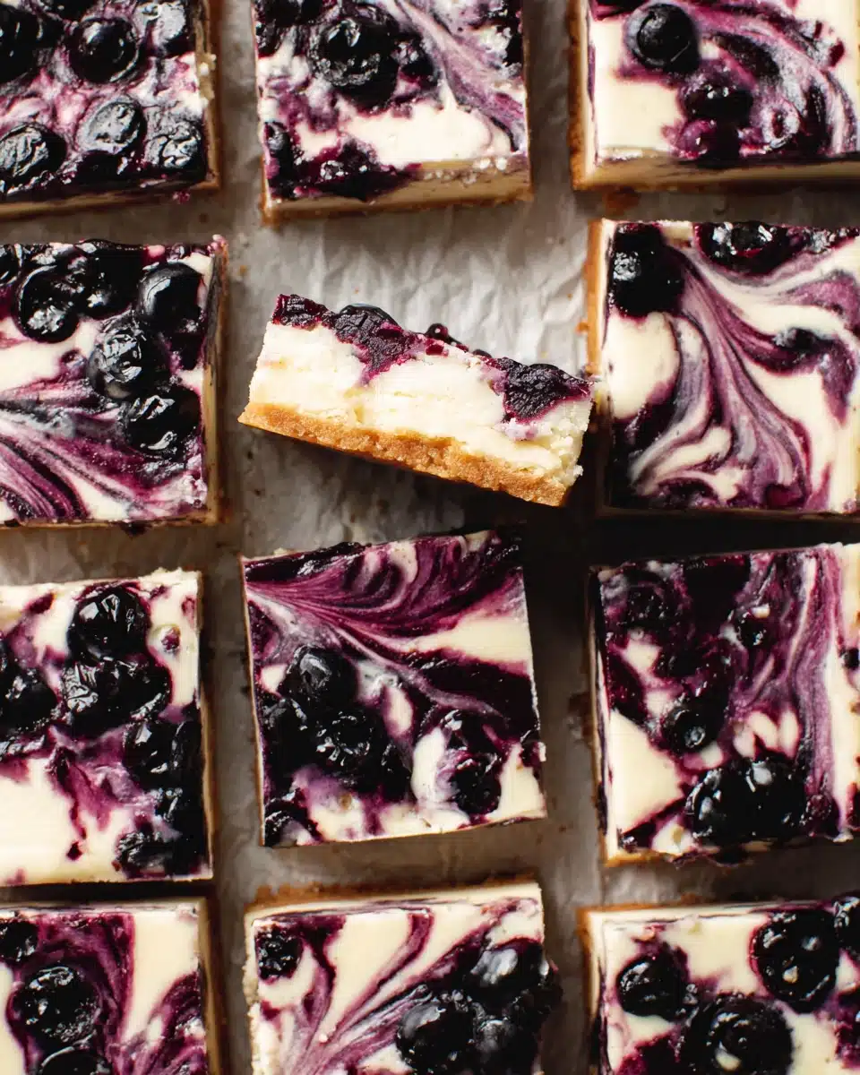 Lemon blueberry cheesecake bars with creamy filling and blueberry swirl