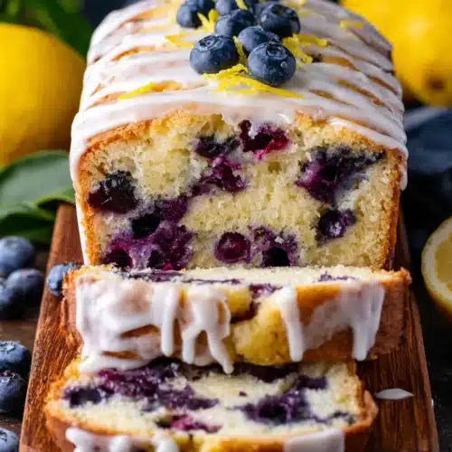Lemon Blueberry Yogurt Cake: A Delightfully Moist Treat 1 Lemon blueberry yogurt cake with white icing and fresh blueberries