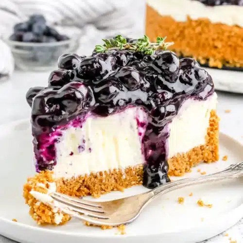 No Bake Blueberry Cheesecake: A Delightfully Easy Dessert 1 No bake blueberry cheesecake slice with graham cracker crust and glossy blueberry topping
