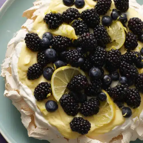Pavlova with lemon curd and fresh berries dessert.
