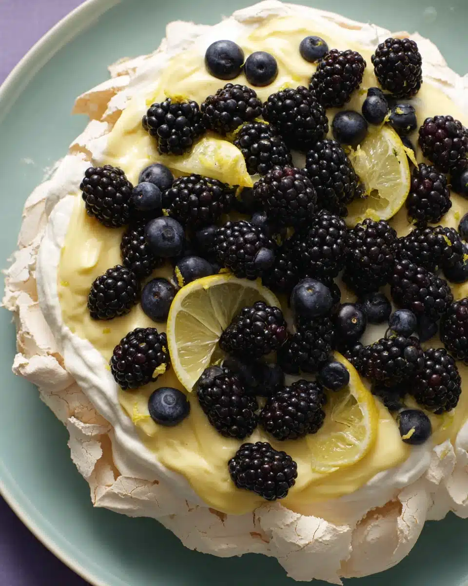 Pavlova with lemon curd and fresh berries dessert.