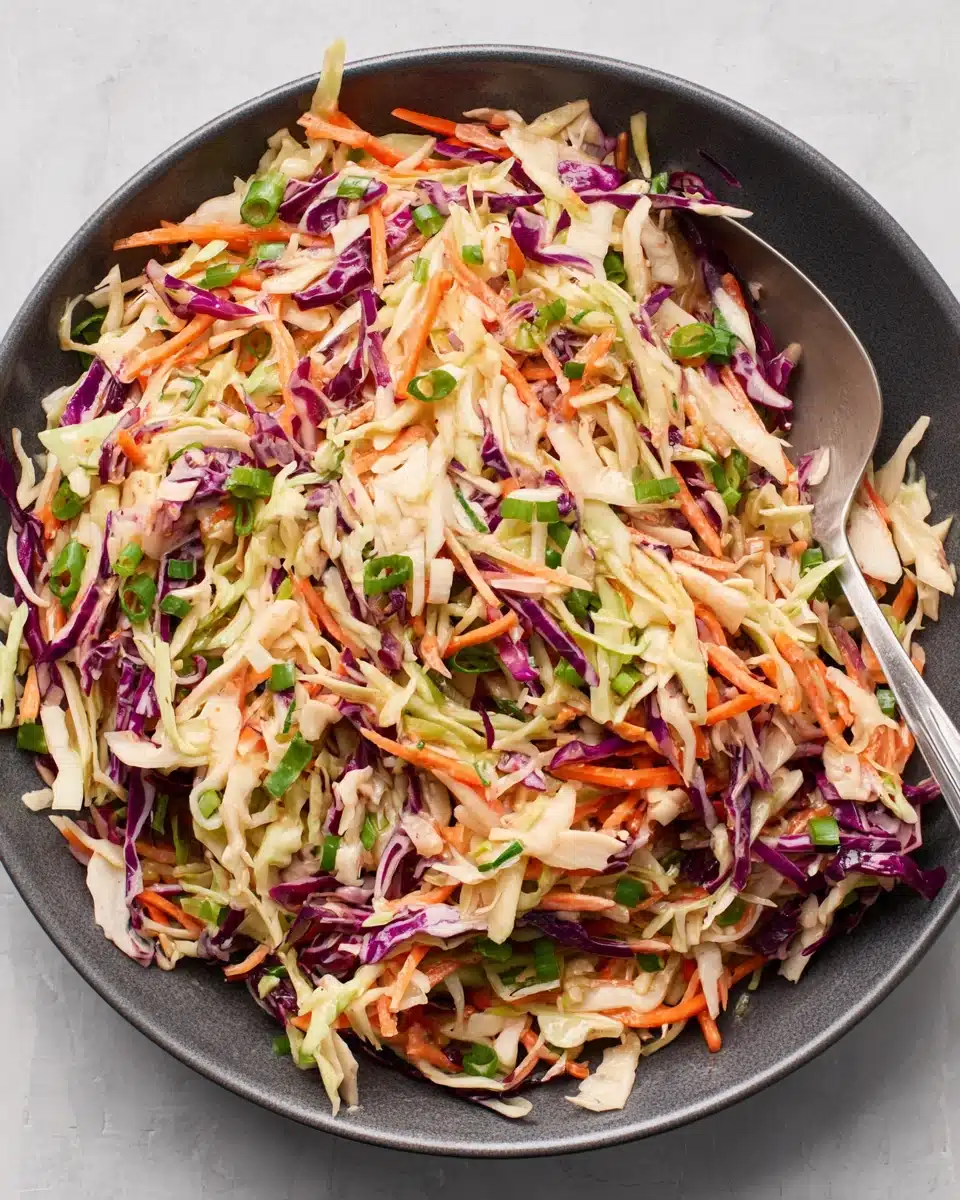 Perfect slaw recipe with colorful cabbage, carrots, and green onions in a bowl