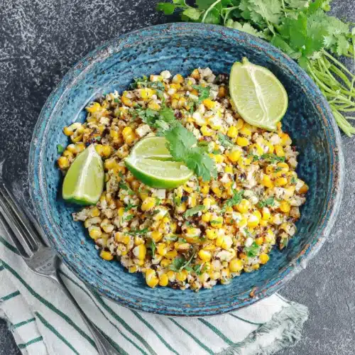 Pioneer Woman Mexican Street Corn Salad with charred corn, lime, and herbs in a blue bowl