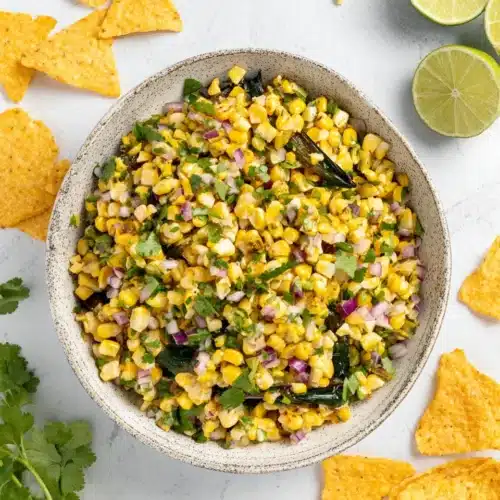 Roasted corn salsa with charred peppers, corn, cilantro, and lime, served with tortilla chips