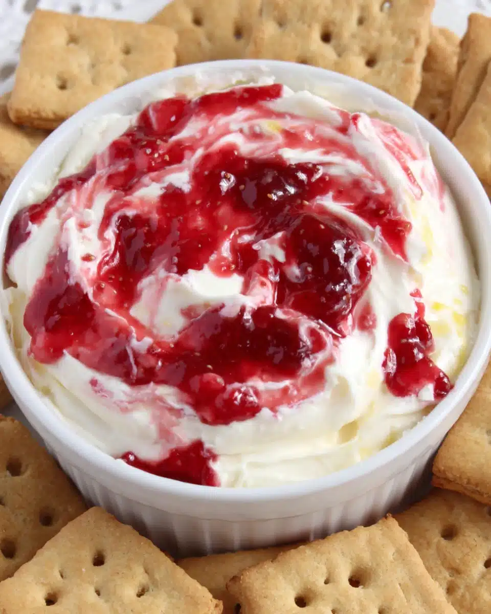 Strawberry Cheesecake Dip with Graham Crackers Strawberry cheesecake dip in a white bowl with graham crackers
